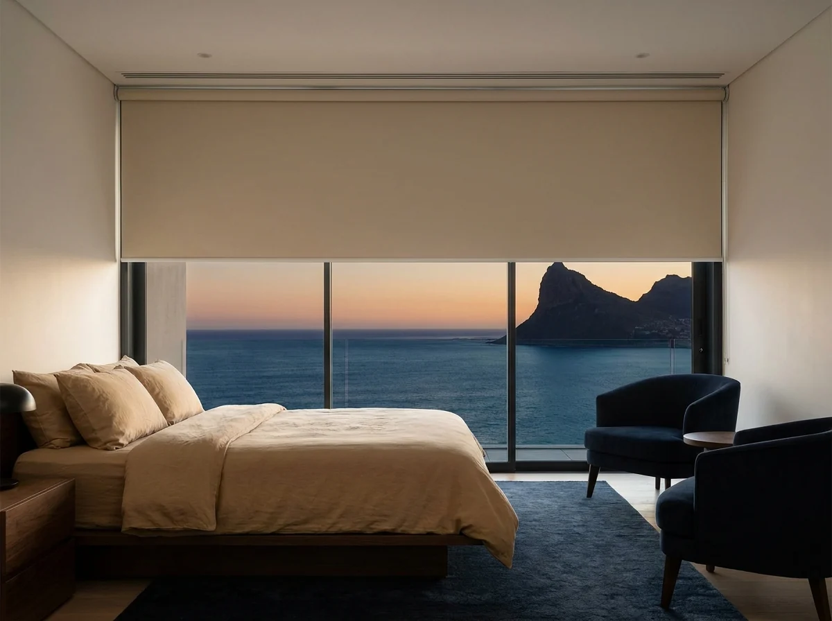 Blockout roller blind lowered over a bedroom window with Atlantic and Lion's Head views in a Fresnaye home
